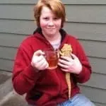 child holding mug of tea