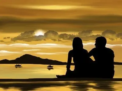 couple sitting in front of sunsett